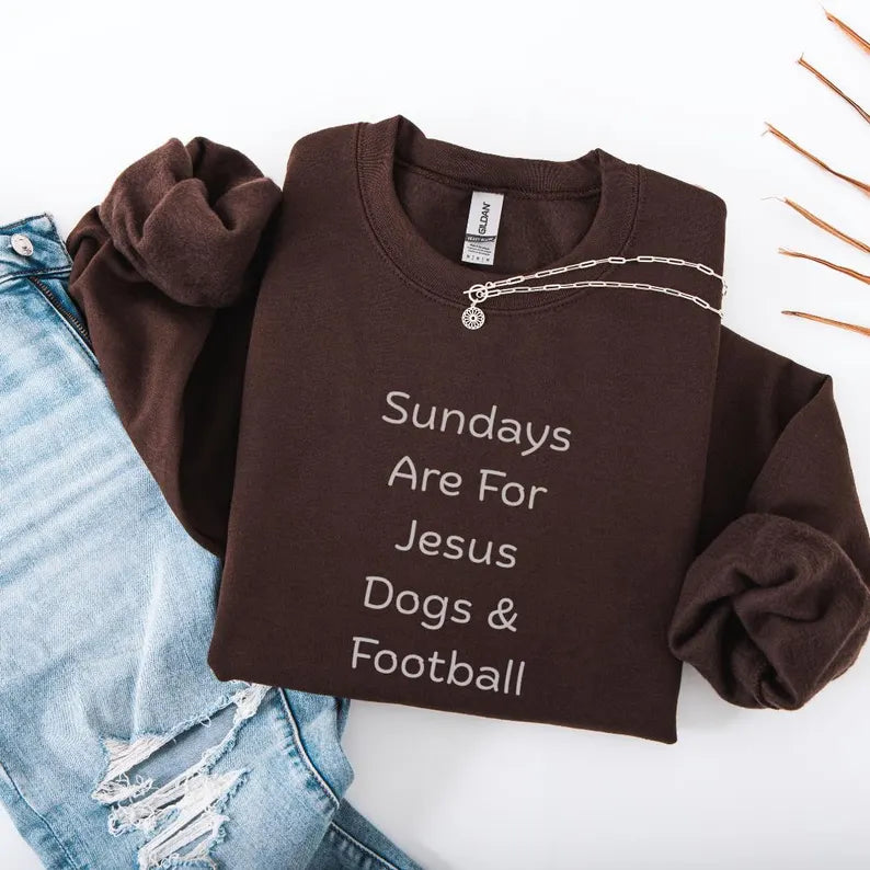 Brown sweatshirt with text 'Sundays Are For Jesus, Dogs & Football' on a white background