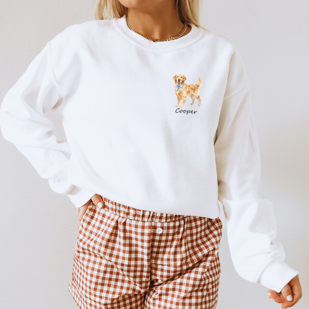 White sweatshirt with a dog illustration and 'Cooper' text, worn by a person with plaid pants.